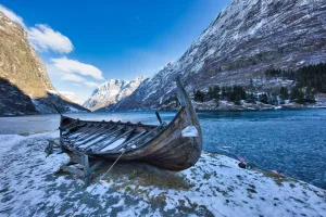 Old Wooden Boat on a Snowy Shore, Norway